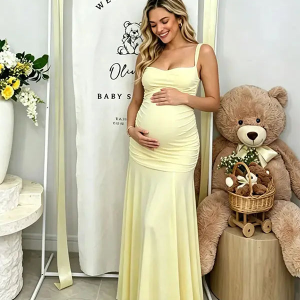 Butter Yellow ruched corset maternity maxi dress with adjustable straps, made from high-stretch milk silk fabric, elegant backless baby shower gown for maternity photoshoot and special occasions.
