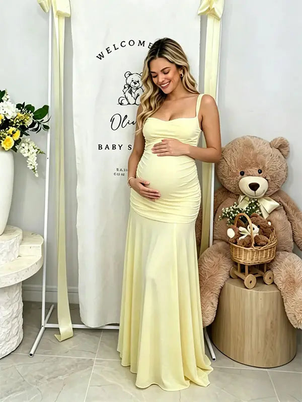 Butter Yellow ruched corset maternity maxi dress with adjustable straps, made from high-stretch milk silk fabric, elegant backless baby shower gown for maternity photoshoot and special occasions.