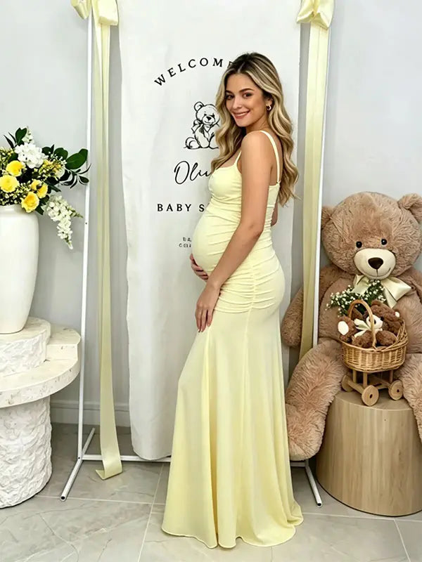 Butter Yellow ruched corset maternity maxi dress with adjustable straps, made from high-stretch milk silk fabric, elegant backless baby shower gown for maternity photoshoot and special occasions.
