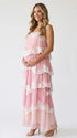 a pink tiered lace maternity maxi dress with layered chiffon, white lace trim, and an adjustable lace-up back for baby shower, maternity photoshoot, gender reveal, and bridal shower.