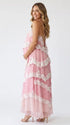 A pink tiered lace maternity maxi dress with layered chiffon, white lace trim, and an adjustable lace-up back for baby shower, maternity photoshoot, gender reveal, and bridal shower.