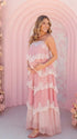 A pink tiered lace maternity maxi dress with layered chiffon, white lace trim, and an adjustable lace-up back for baby shower, maternity photoshoot, gender reveal, and bridal shower.