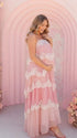 A pink tiered lace maternity maxi dress with layered chiffon, white lace trim, and an adjustable lace-up back for baby shower, maternity photoshoot, gender reveal, and bridal shower.