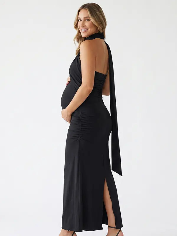 black halter maternity maxi dress with ruched bodycon silhouette and cross neck detail