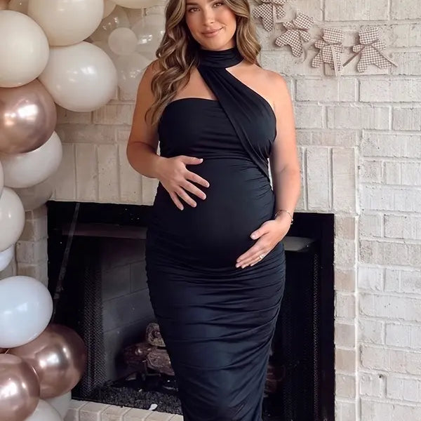 black halter maternity maxi dress with ruched bodycon silhouette and cross neck detail