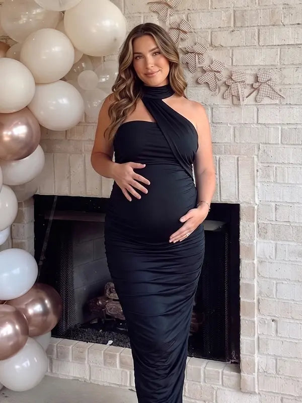 black halter maternity maxi dress with ruched bodycon silhouette and cross neck detail