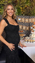 black jacquard maternity midi dress with corset bodice and high low hem