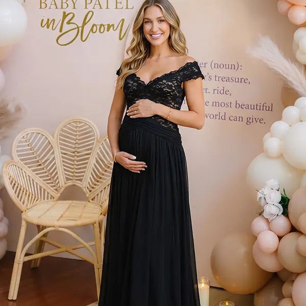 A black lace off shoulder maternity maxi dress with a flowing chiffon skirt for baby shower, maternity photoshoot, gender reveal and formal pregnancy occasions.