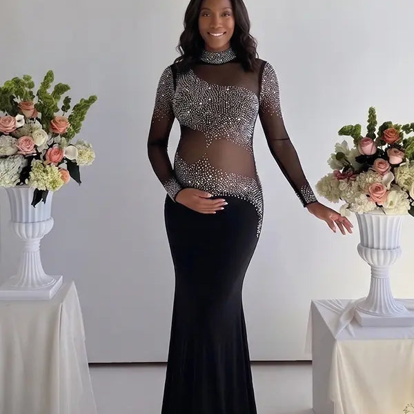 Pregnant woman wearing a black long sleeve rhinestone illusion mesh maternity mermaid maxi dress for luxury maternity photoshoots, baby showers, pregnancy announcements, editorial portraits, and formal events.