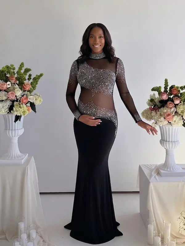 Pregnant woman wearing a black long sleeve rhinestone illusion mesh maternity mermaid maxi dress for luxury maternity photoshoots, baby showers, pregnancy announcements, editorial portraits, and formal events.
