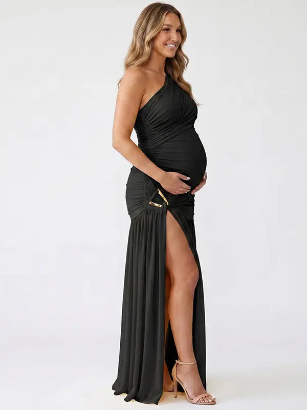 Black one shoulder maternity gown with ruched silhouette and high slit for elegant pregnancy photoshoots
