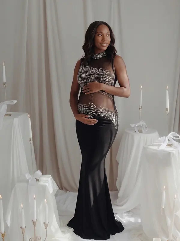 A black rhinestone illusion mesh maternity mermaid maxi dress for luxury maternity photoshoots, baby showers, editorial portraits, and formal pregnancy events.