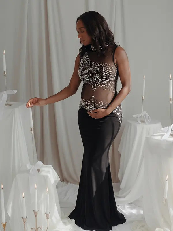A black rhinestone illusion mesh maternity mermaid maxi dress for luxury maternity photoshoots, baby showers, editorial portraits, and formal pregnancy events.