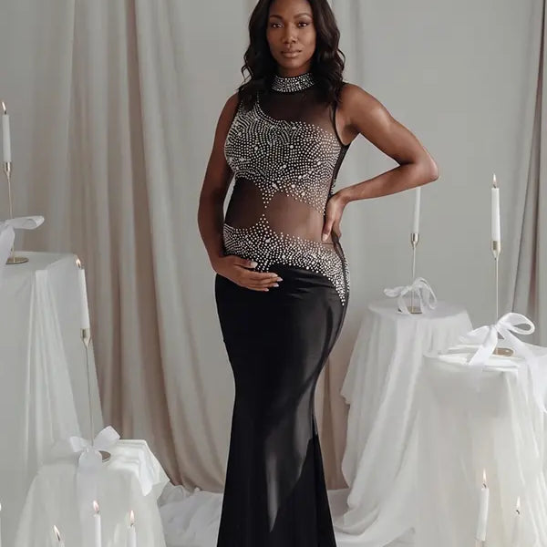 A black rhinestone illusion mesh maternity mermaid maxi dress for luxury maternity photoshoots, baby showers, editorial portraits, and formal pregnancy events.