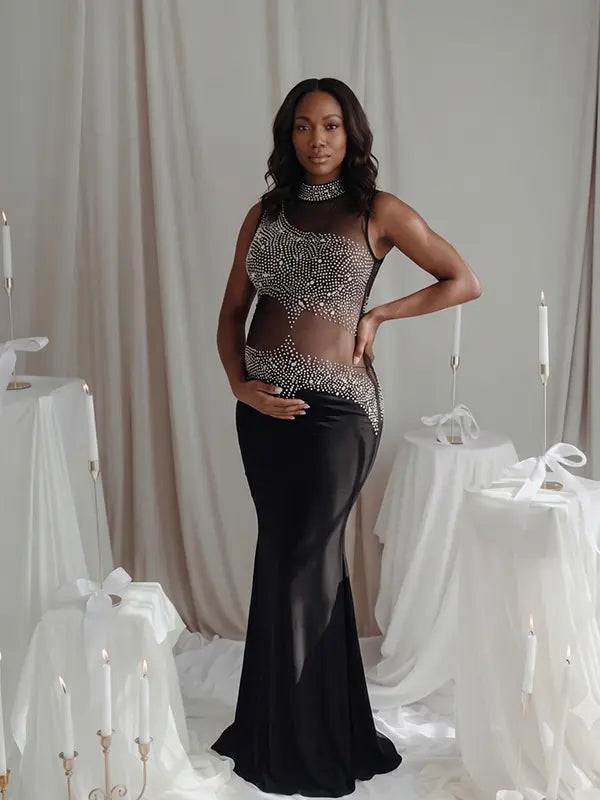 A black rhinestone illusion mesh maternity mermaid maxi dress for luxury maternity photoshoots, baby showers, editorial portraits, and formal pregnancy events.