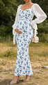 Pregnant woman wearing blue floral maternity dress for maternity photoshoot