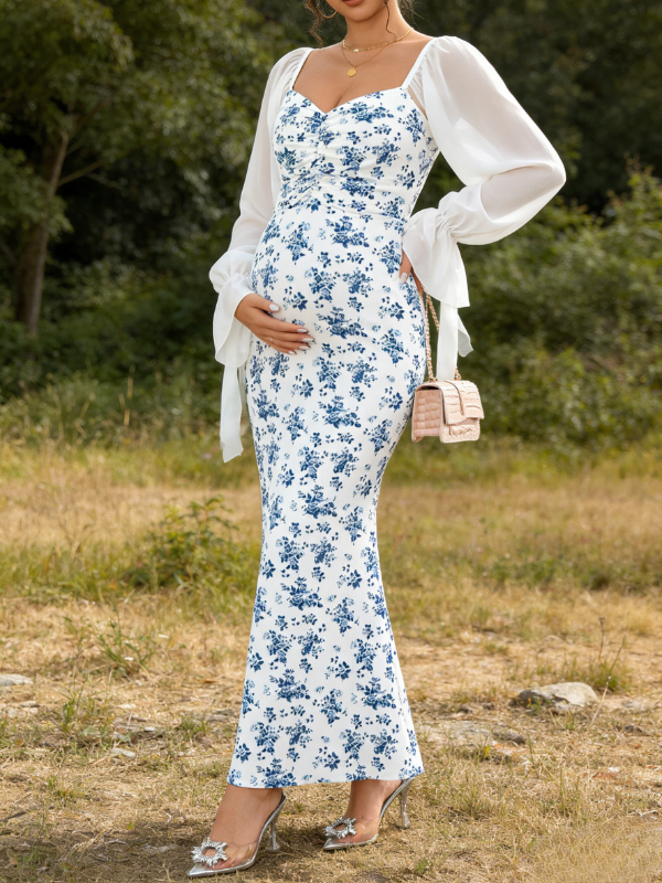 Pregnant woman wearing blue floral maternity dress for maternity photoshoot