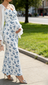 Side view of pregnant woman wearing  biue floral maternity dress for maternity photoshoot