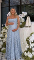 Pregnant woman wearing blue floral open back maternity maxi dress for baby shower photoshoot