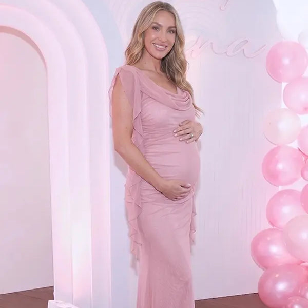 blush pink mesh maternity gown with draped cowl neckline and cascading ruffle sleeves