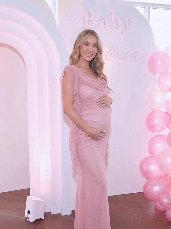 blush pink mesh maternity gown with draped cowl neckline and cascading ruffle sleeves