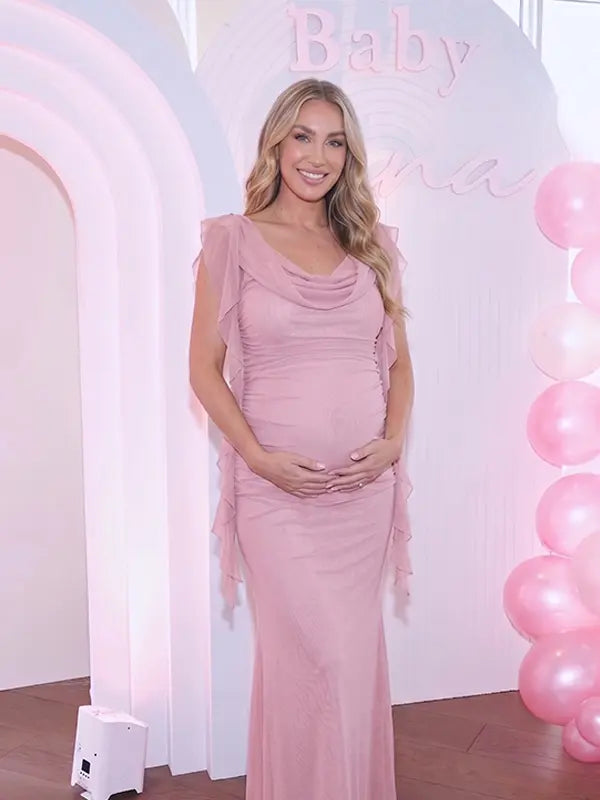 blush pink mesh maternity gown with draped cowl neckline and cascading ruffle sleeves