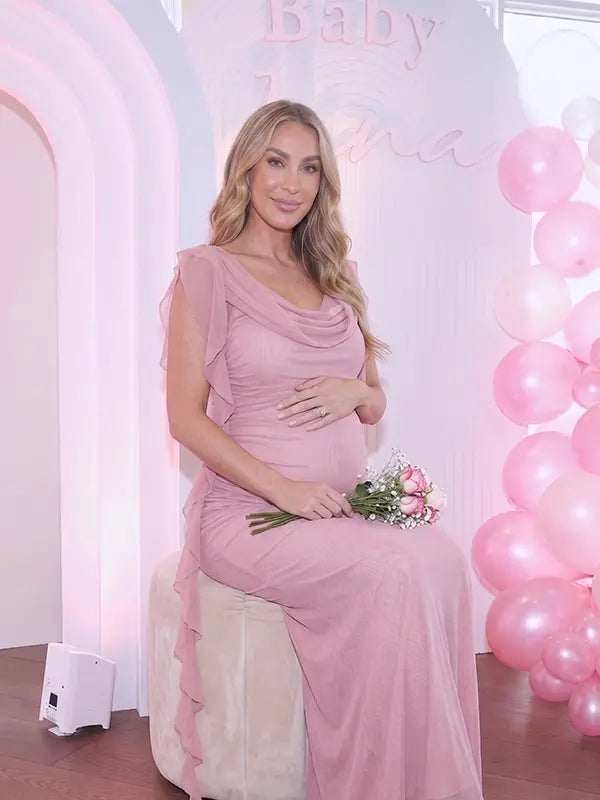 blush pink mesh maternity gown with draped cowl neckline and cascading ruffle sleeves