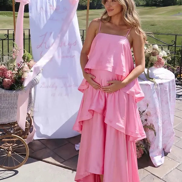 blush pink tiered ruffle maternity maxi dress with flowy layers and spaghetti straps