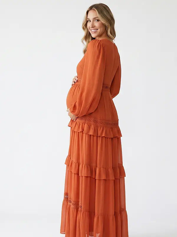 burnt orange lace trim maternity maxi dress with long sleeves and flowing tiered skirt