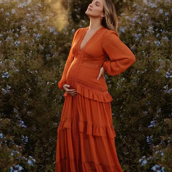 burnt orange lace trim maternity maxi dress with long sleeves and flowing tiered skirt