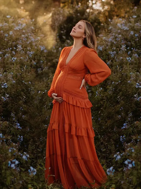 burnt orange lace trim maternity maxi dress with long sleeves and flowing tiered skirt