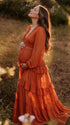 burnt orange lace trim maternity maxi dress with long sleeves and flowing tiered skirt