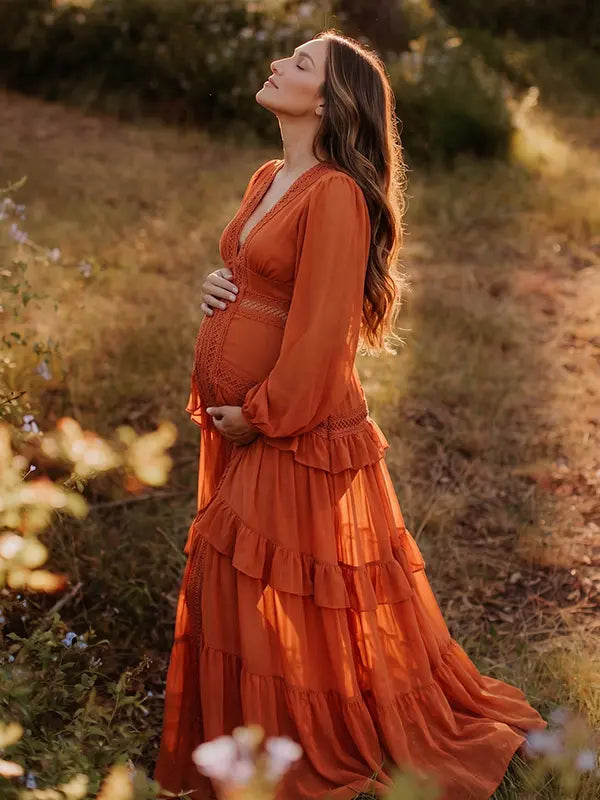 burnt orange lace trim maternity maxi dress with long sleeves and flowing tiered skirt