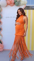 Burnt orange fringe halter maternity maxi dress with tassel hem, bodycon pregnancy gown for fall baby showers, pumpkin patch maternity photoshoots, harvest celebrations, and autumn pregnancy portraits.