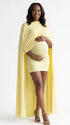 butter yellow maternity cape dress with bodycon mini silhouette and dramatic flowing drape
