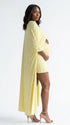 butter yellow maternity cape dress with bodycon mini silhouette and dramatic flowing drape