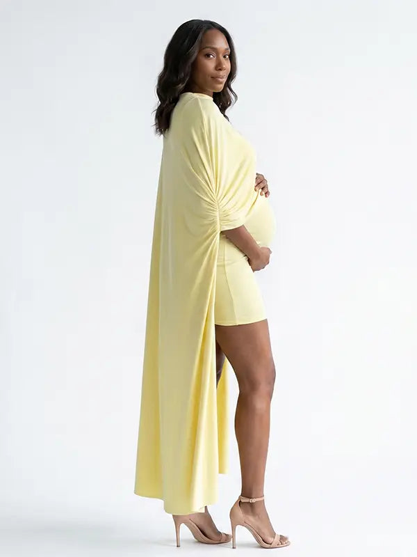 butter yellow maternity cape dress with bodycon mini silhouette and dramatic flowing drape