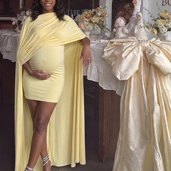 butter yellow maternity cape dress with bodycon mini silhouette and dramatic flowing drape