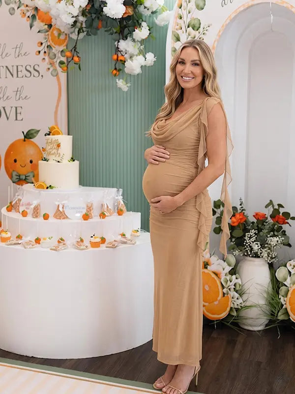 champagne beige maternity gown with draped neckline and cascading mesh ruffle details