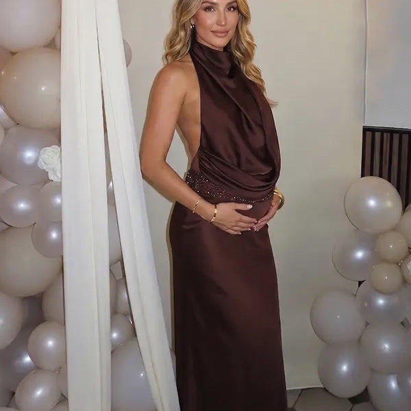 chocolate brown halter maternity gown with open back design and beaded waist detail