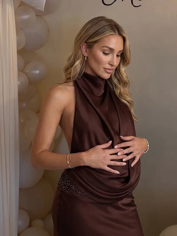 chocolate brown halter maternity gown with open back design and beaded waist detail
