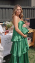 green tiered ruffle maternity maxi dress with spaghetti straps and layered ruffles