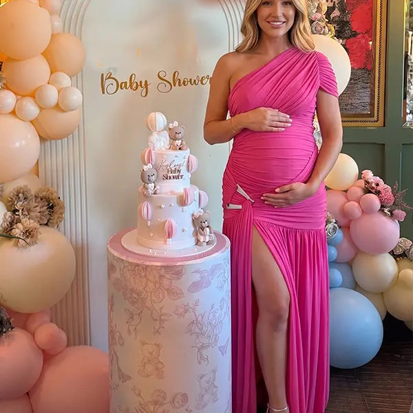 Hot pink one shoulder maternity gown with ruched silhouette and high slit for Barbie baby shower celebrations