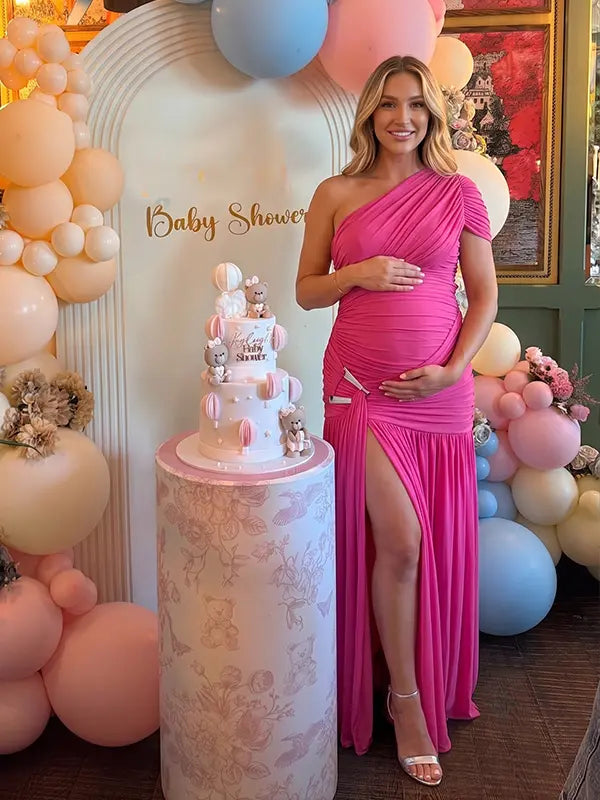 Hot pink one shoulder maternity gown with ruched silhouette and high slit for Barbie baby shower celebrations