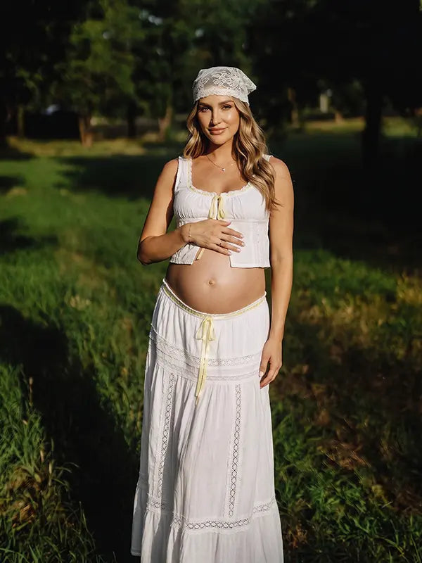 Ivory Boho Lace Two Piece Maternity Photoshoot Outfit Featuring a Tie Front Crop Top and Flowing Tiered Maxi Skirt for Boho Pregnancy Photography, Beach Maternity Sessions and Pregnancy Announcements | Bumplook