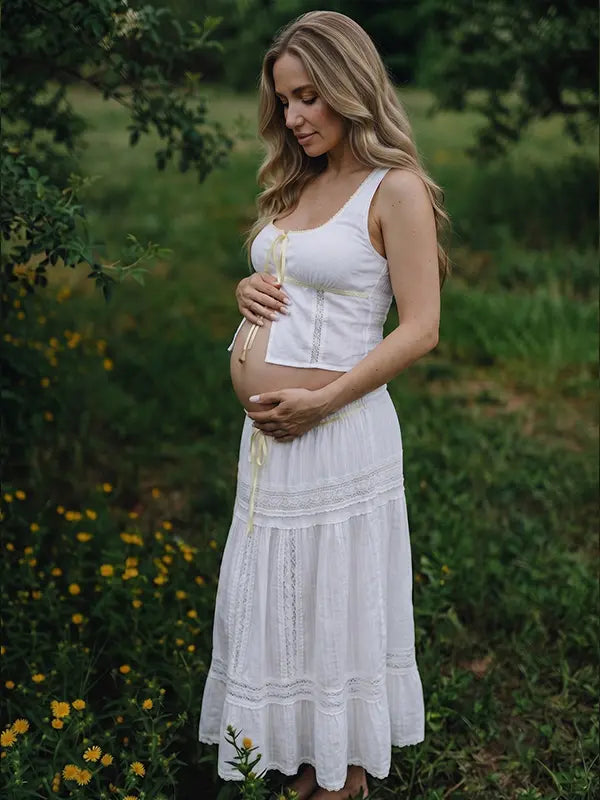 Ivory Boho Lace Two Piece Maternity Photoshoot Outfit Featuring a Tie Front Crop Top and Flowing Tiered Maxi Skirt for Boho Pregnancy Photography, Beach Maternity Sessions and Pregnancy Announcements | Bumplook
