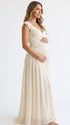 Pregnant model wearing an ivory lace chiffon maternity maxi dress with floral lace bodice, flutter sleeves and flowing skirt for boho baby shower, maternity photoshoot and bridal celebration.