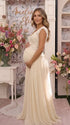 An ivory lace chiffon maternity maxi dress with floral lace bodice, flutter sleeves and flowing skirt for boho baby shower, maternity photoshoot and bridal celebration.