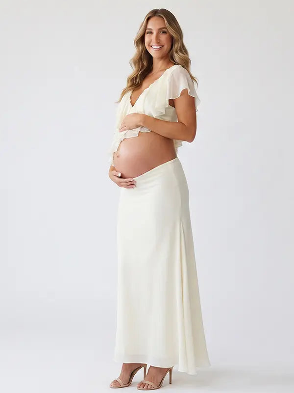 Ivory Ruffle Two Piece Maternity Photoshoot Outfit Featuring an Open Belly Design and Flowing Maxi Skirt for Pregnancy Photography, Studio Maternity Portraits and Pregnancy Announcements | Bumplook