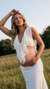 Ivory Ruffle Two Piece Maternity Photoshoot Outfit Featuring an Open Belly Design and Flowing Maxi Skirt for Pregnancy Photography, Studio Maternity Portraits and Pregnancy Announcements | Bumplook